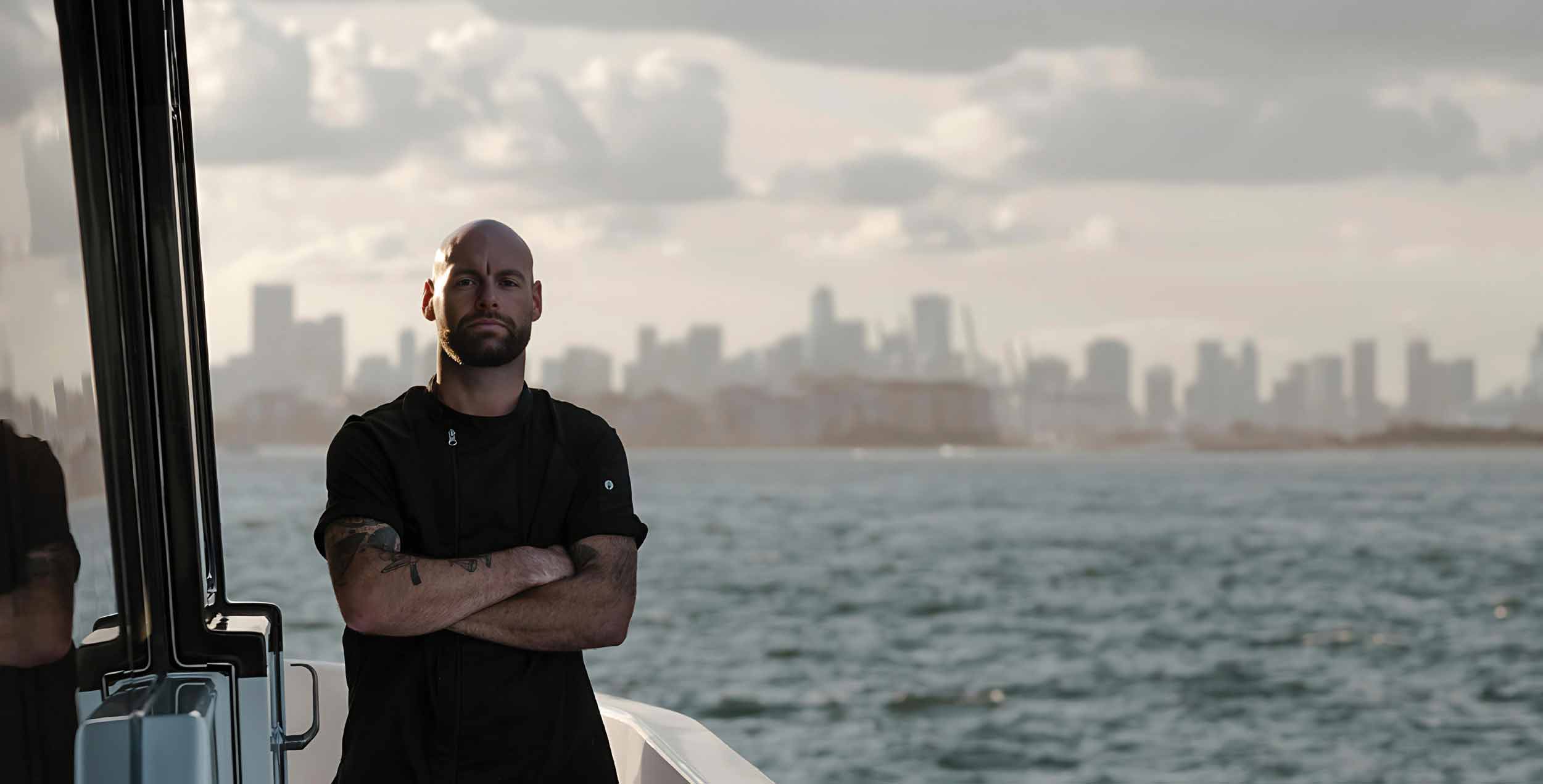 chef dave on a boat with a view of the city