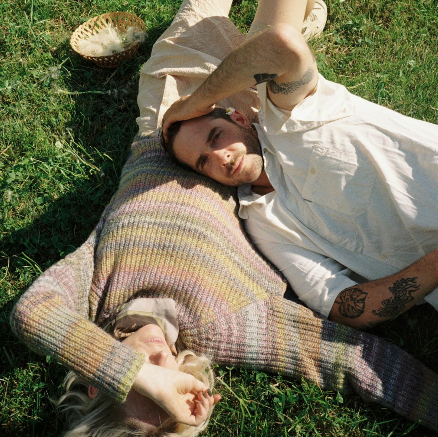 a man and woman laying on the grass